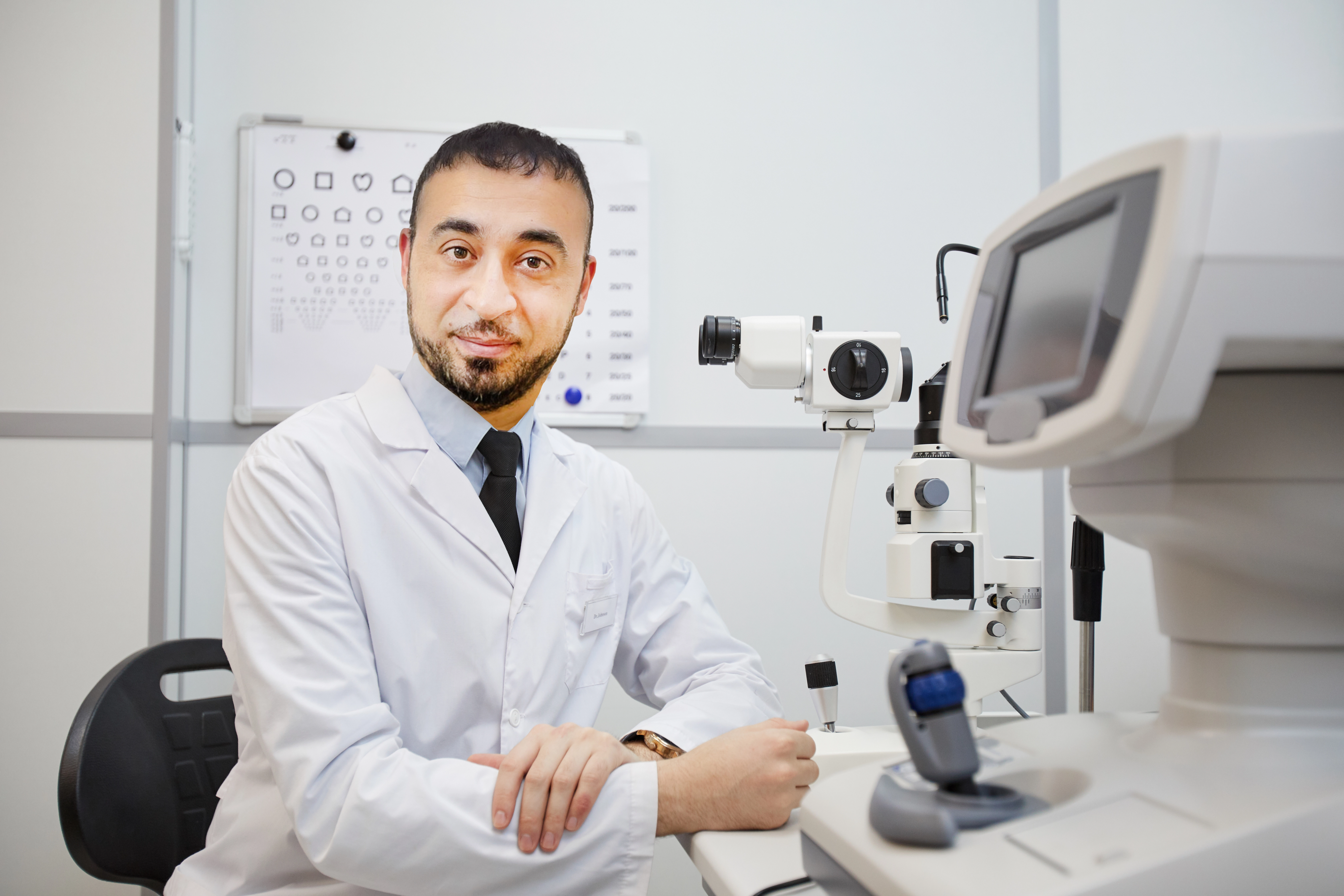 Optometrist examining a young patient's eyes